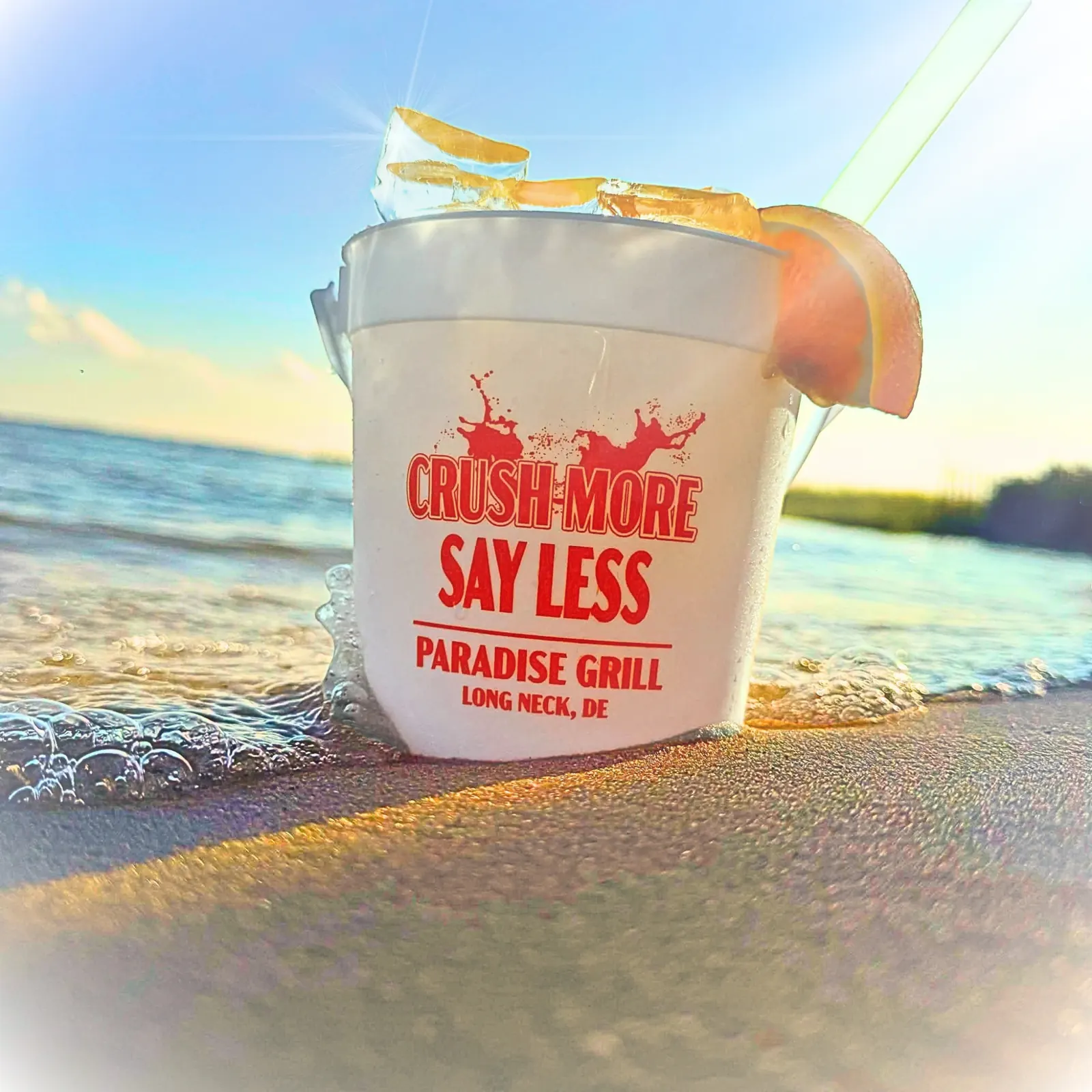 A Paradise Grill orange crush on the beach beside the bay