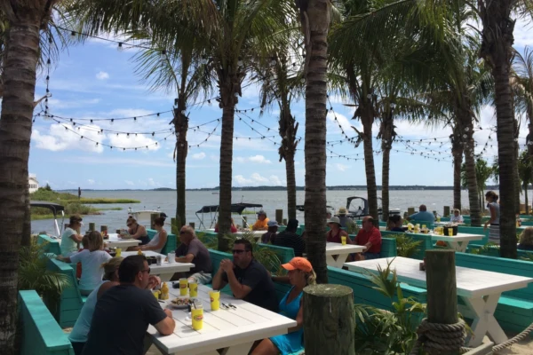 Waterfront tables under palms
