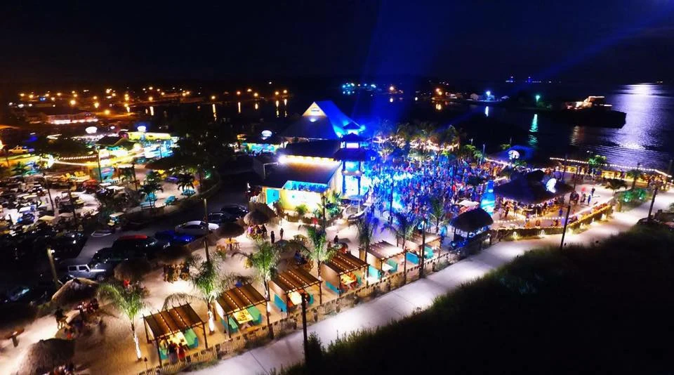 Paradise Grill illuminated at night beside the Indian River Bay